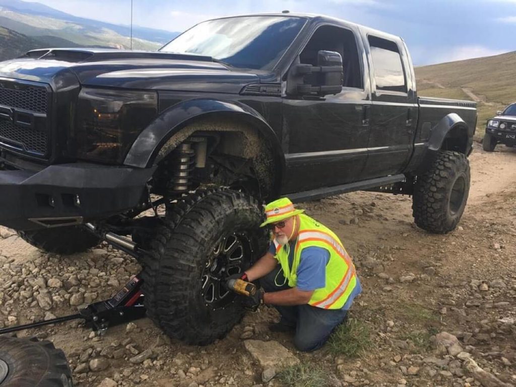 Kingston Peak: Truck with 43s and sliced sidewalls and stripped lug nuts.